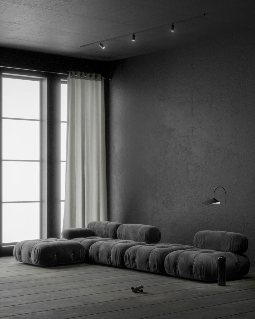 Salón en penumbra con muros de mortero gris y sofá modular